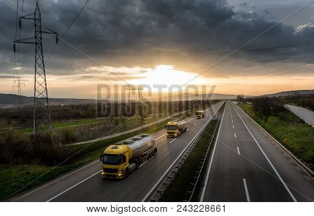 Caravan Or Convoy Of Tank Trucks In Line On A Country Highway