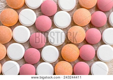 White, Pink And Orange Tablets Stripes Background. Different Antacids Medications Help Neutralize St