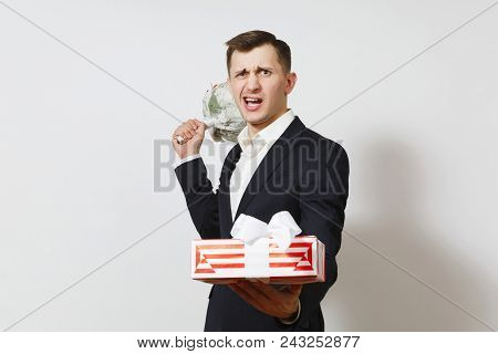 Young Crazy Angry Perturbed Man In Suit Holding Bouquet Of Roses Flowers, Red Present Box With Gift 