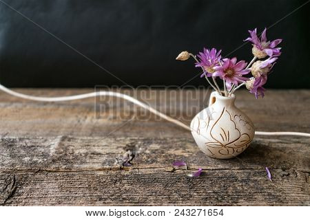 Bouquet Of Few Lilac Flower Xeranthemum On Round Clay Vase On Wooden Texture Background Close Up. Wa
