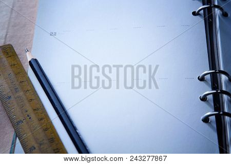 dairy or noote book open page with pencil and ruler