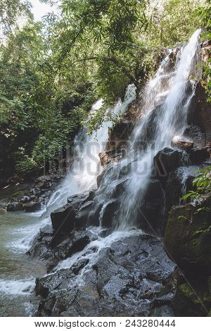 Scenic View Of Beautiful Kanto Lampo Waterfall, Green Plants And Rocks, Bali, Indonesia