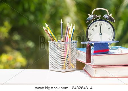 Graduate Or Education Knowledge Study Abroad Concept : Graduation Cap On Textbook With Pencil Box An