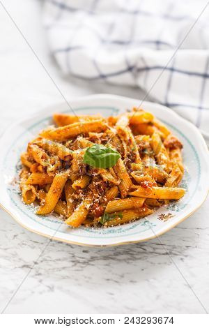 Italian Food And Pasta Pene With Bolognese Sause On Plate