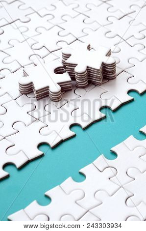 The Blue Path Is Laid On The Platform Of A White Folded Jigsaw Puzzle. The Missing Elements Of The P