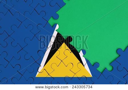 Saint Lucia Flag  Is Depicted On A Completed Jigsaw Puzzle With Free Green Copy Space On The Right S