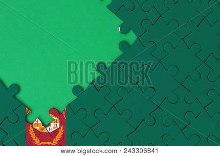 Turkmenistan Flag  Is Depicted On A Completed Jigsaw Puzzle With Free Green Copy Space On The Left S