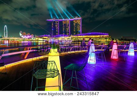 Singapore - April 28, 2018: Marina Bay Sands With Colored Lights During Laser Show Seen From Roof Of