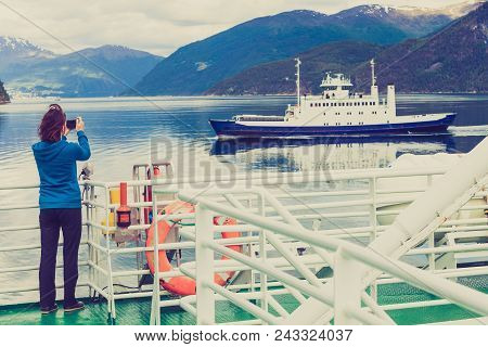 Tourism Vacation And Travel. Tourist Woman On Cruise Ship Enjoying Fjord View, Taking Photo With Cam