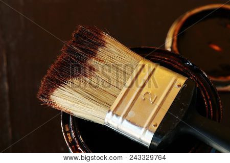 A Plastic Brush Soaked Brown Paint On The Top Of Can. It Means That Painter Has Break