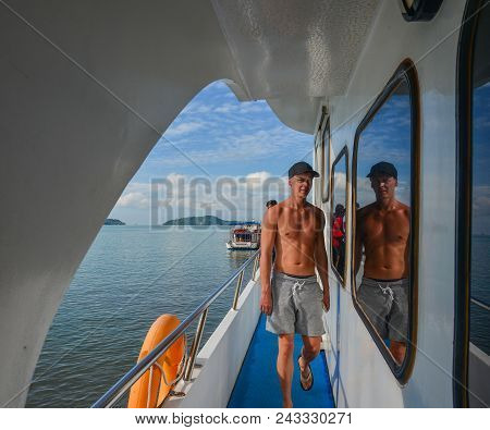 Phuket, Thailand - Apr 26, 2018. A Man On Tourist Cruise In Phuket, Thailand. Phuket Lies Off The We