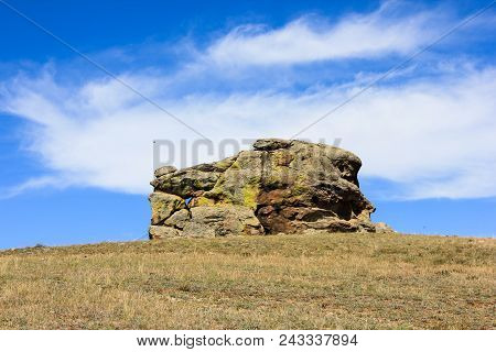 Big Inexplicable Square Stone Structure Under The Summer Blue Sky With White Clouds In Suvinian Saxo
