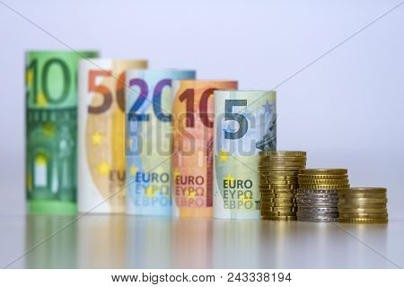 Straight Row Of Accurately Rolled Hundred, Fifty, Twenty, Ten And Five New Paper Euro Banknotes And 