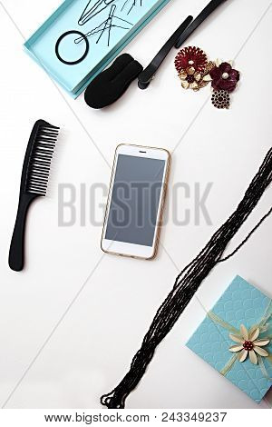 Smartphone, Accessories And Hair Pins Flat Lay. Sponge For Hair, Hairdo Babette. Necklaces Of Beads 