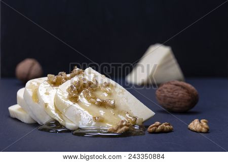 Suluguni Cheese, Walnut And Honey On Black Slate Platter Background , Close Up