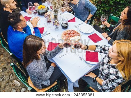 Friends Having Dinner In Garden