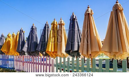 Colorful Sun Umbrellas On The Playground On A Clear Sunny Day