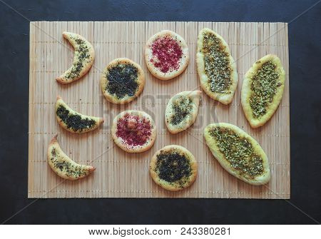 Herb Scones With Spices On A Bamboo Napkin On A Black Table.