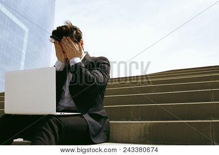Young Confidental Businessman Wearing Suit And Using Modern Laptop Outdoors. Successful Banker Worki
