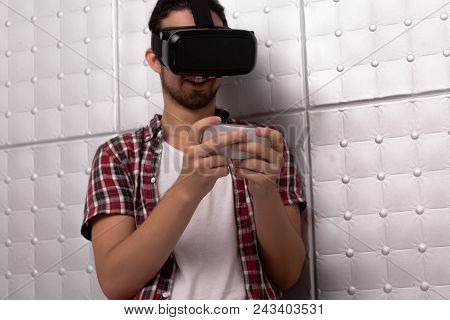 Well Built Man In Virtual Reality Glassess. Playing On Smartphone.