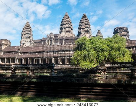Temple Angkor Wat With Blue Sky And A Tree In Cambodia