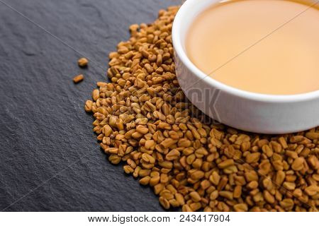 Fragrant Grains Of Fenugreek On A Rustic Background.
