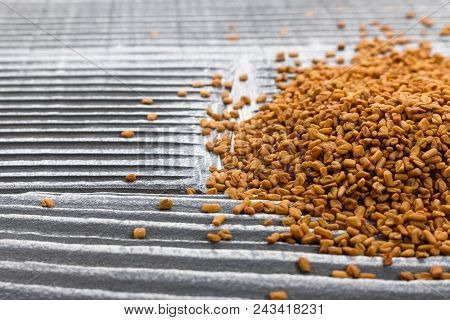 Fragrant Grains Of Fenugreek On A Rustic Background.