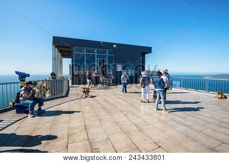 Gibraltar, Uk - May 18, 2017: Tourists And Barbary Apes On The Viewing Platform At Cable Car Upper S