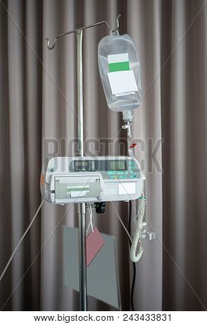 Normal Saline Solution For Patient In The Hospital Against Fabric Curtain Background