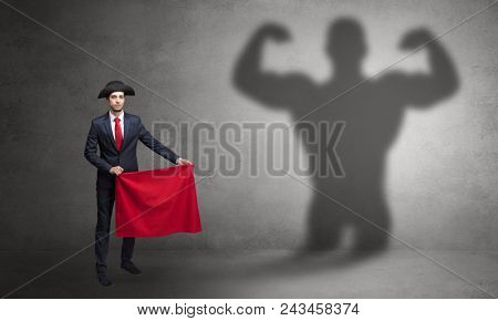 Businessman standing with red cloth on his hand and strong hero shadow on the background