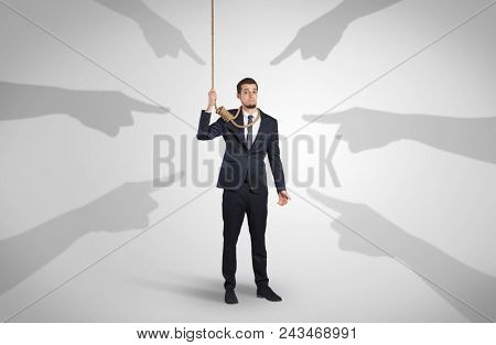 Young businessman trying to suicide with pointing hands concept