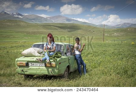 Family With Their Car In A Countryside