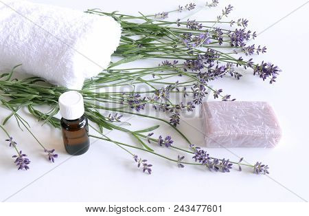 Spa Treatment And Massage Products With Towel, Aromatic Oil , Natural Soap And Lavender Flowers On A