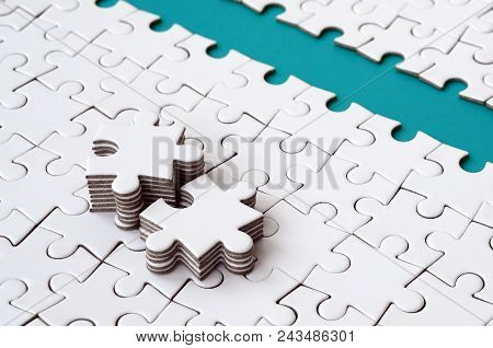The Blue Path Is Laid On The Platform Of A White Folded Jigsaw Puzzle. The Missing Elements Of The P