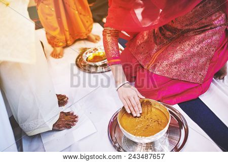 Women Preparaing For Pasting The Turmeric (haldi) Oil Mixed With Milk On Bride's Feet And Body