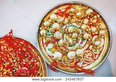 The Golden Choora With Red Thread On The Plate, The Items For Rituals Of Indian Marriage Ceremony