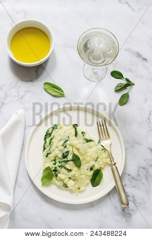 Gentle Cream Risotto With Spinach, Served With Wine. Light Background, Selective Focus.