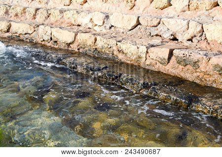Old Ancient Yellow Stone Steps Covered With Brown Friable Sand With Waves And Irregularities, Descen