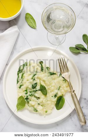 Gentle Cream Risotto With Spinach, Served With Wine. Light Background, Selective Focus.