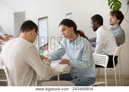 Concentrated Young Female Worker Consulting Male Client, Helping To Fill In And Sign Documents, Advi