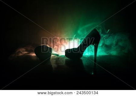 Black Suede High Heel Women Shoes On Dark Toned Foggy Background. Close Up. Women Power Or Women Dom