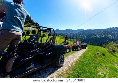 A Tour Group Travels On Atvs And Utvs On The Mountains.