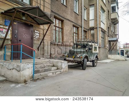 Novosibirsk, Russia - 05.14.2018: Russian Old Car Gaz 69 Near The House. Photography Of A Classic Ol