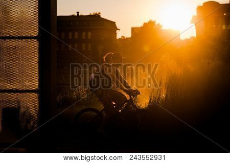 Moscow, Russia - June 25, 2016: A Guy Riding A Bicycle At Sunset In The Museon Art Park.