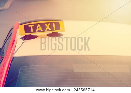 Taxi Car Is Waiting For A Passenger On The Street. European Tourism And Travel Concept. Toned.