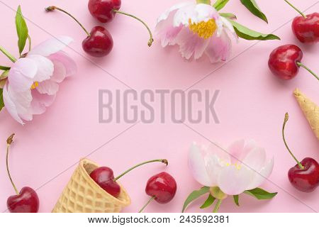 Spring Or Summer Mood Concept. Flatlay Of Cerry, Sweet Cones And Peonies Over Pastel Pink Background