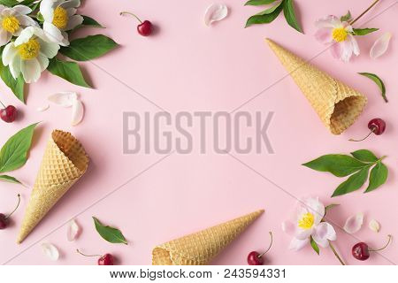 Flatlay Of Cerry, Sweet Cones And Peonies Over Pastel Pink Background. Top View With Space For Your 