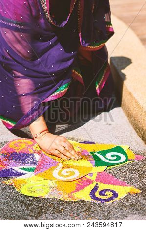 Women Decorating And Coloring Tradition Colorful Rice Art Or Sand Art (rangoli) On The Floor With Pa