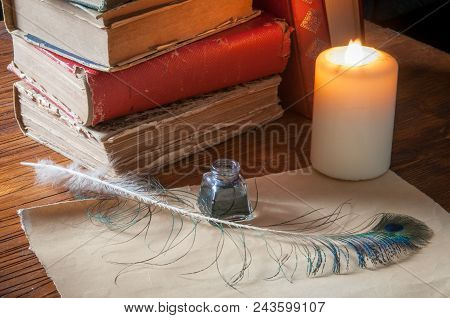 Green Quil Pen And Black Inkwell With Old Papers And Books