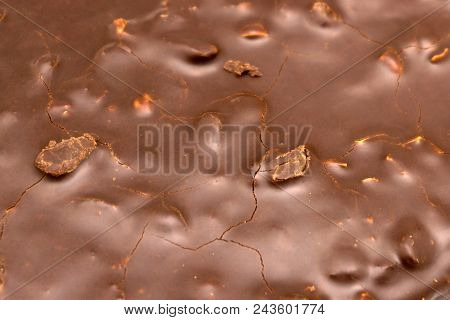Macro Close Up Of Fine Chocolate Chopped By Hand, Sliced Off The Block With A Knife